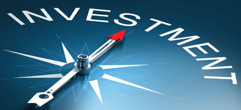 Investment compass pointing upward with "Investment" text, symbolizing financial growth.