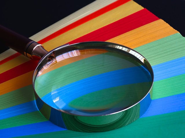 Rainbow color palette with a magnifying glass highlighting the colors.