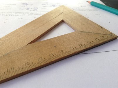 Ruler and pencil for precise measurement on paper.