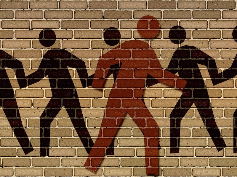 Team collaboration and leadership concept on brick wall background.