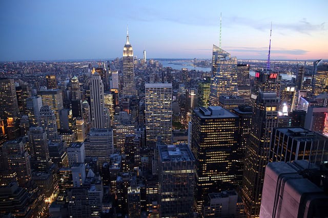 Aerial view of Manhattan skyline with iconic skyscrapers at sunset.